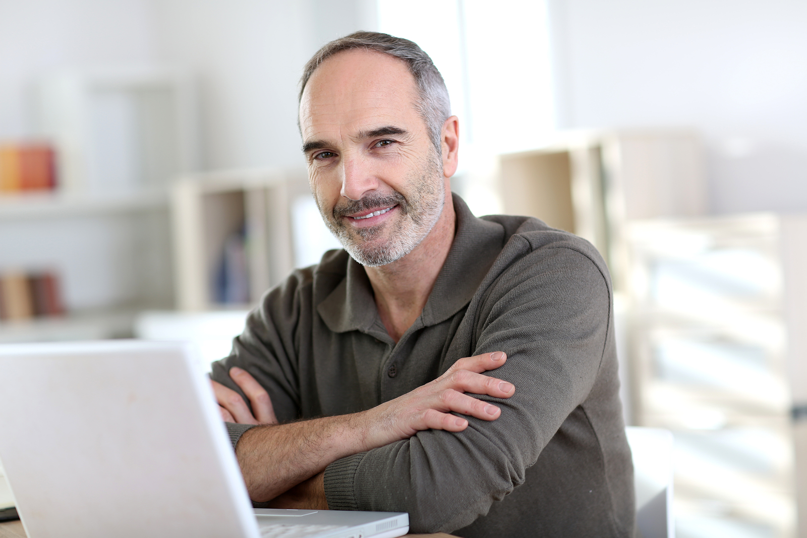 Senior man working from home with laptop computer